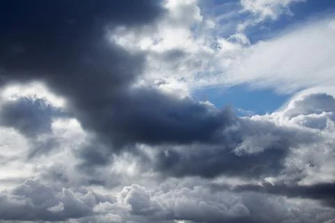 Storm clouds on the sky, torn textured clouds on a blue sky Stock Photos