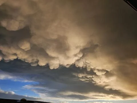 Storm clouds on sunset. Light in the dark and dramatic storm clouds. Background Stock Photos