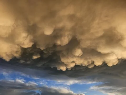 Storm clouds on sunset. Light in the dark and dramatic storm clouds. Background Stock Photos