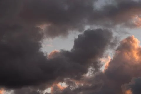 Storm clouds in the sunset light Stock Photos