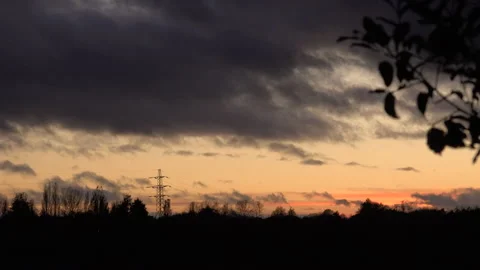 Storm clouds time lapse moving in evening sky over town sky 4K Stock Footage 170139773