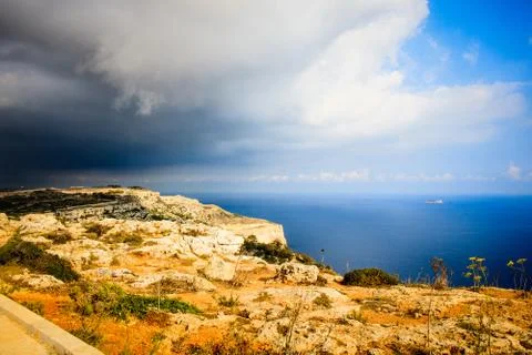 Storm comming in Dingli Cliffs in Malta yellow rocks and blue sea amazing clo Stock Photos