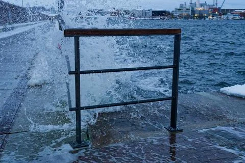 Storm Damage and High Waves Crashing Against Metal Railing at Flensburg Wes.. Stock Photos