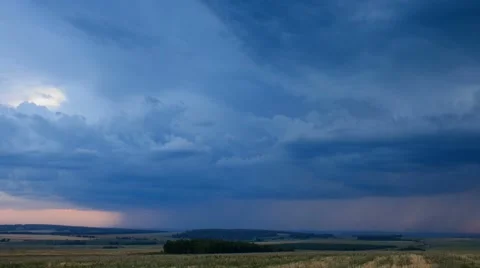 Storm dark clouds over field an sunset Stock Footage 43098607