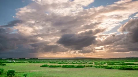 Storm dark clouds over field with green grass and trees. 4k. Time lapse Video stock 57850888