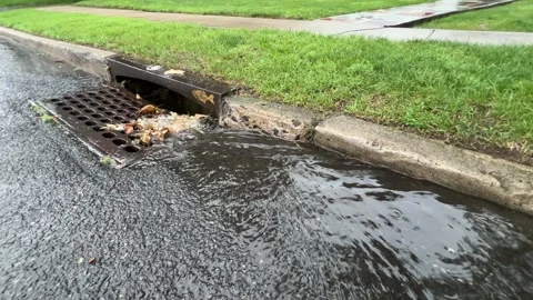 Storm drain on a street Stock Footage 342173491