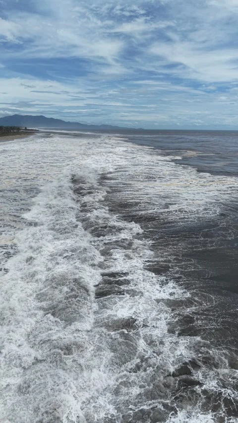 Storm foam patterns on dark ocean water, vertical aerial, Acapulco Stock Footage 348256770
