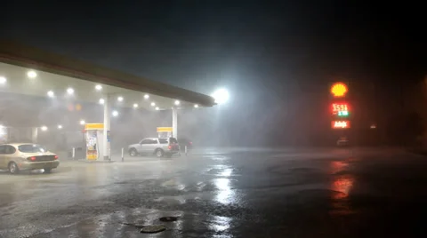 Storm front with blinding rain passes over gas station Stock Footage 30369761