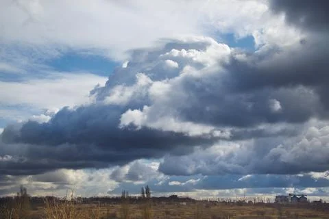 A storm front of clouds low over the ground Stock Photos