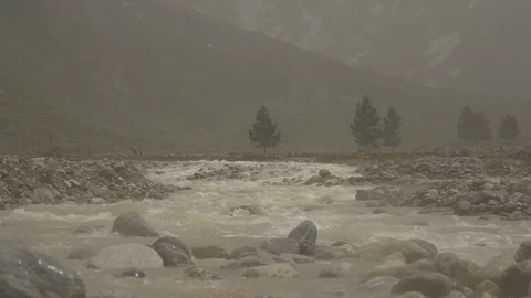 Storm with hail in slow motion over mountain river Stock Footage 77242635