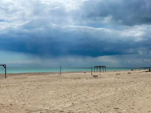 Storm looming on empty sandy sea beach Stock Photos