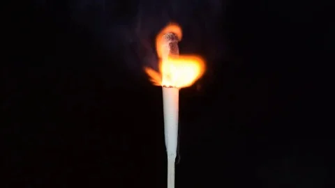 A storm match burns on a black background Stock Footage 76080724