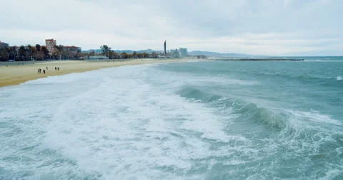 Storm ocean waves breaking on the sandy shore. Big splashes of sea water and Stock-Footage 143640328