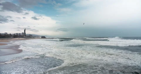 Storm ocean waves breaking on the sandy shore. Big splashes of sea water and Stock-Footage 143640463