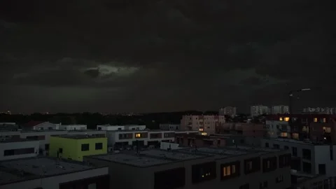 A storm rages through dark clouds over a suburban townscape 動画素材 246314412