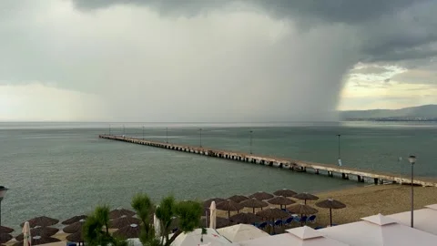 Storm rain falling over Perea beach pier in Thessaloniki Stock Footage 336448243