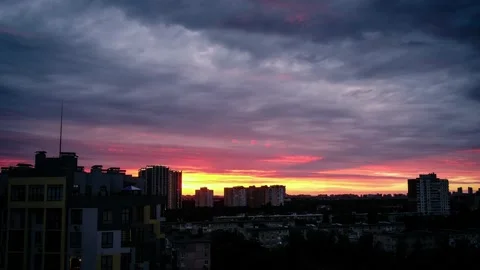 Storm rainy clouds passing over city skyline as sunset sky reflects in window Stock Footage 156411798