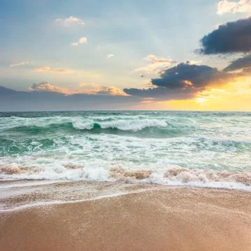 Storm on the sandy beach at sunset Foto stock