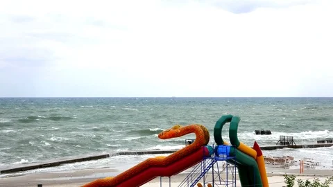 Storm Sea on the beach. Inflatable slides Video stock 70389394