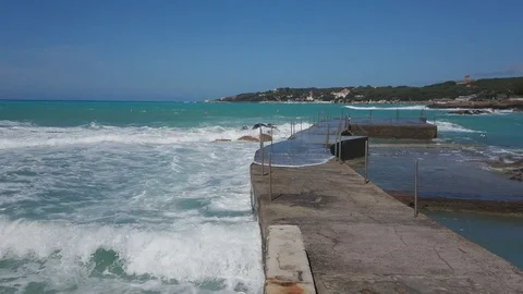 Storm on the sea. Big waves. View from the pier. Blue sky and sea. Stock Footage 108799947