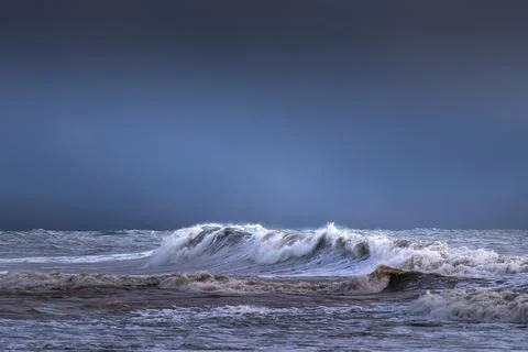 Storm at sea, dramatic sky at sunset, big waves Stock Photos