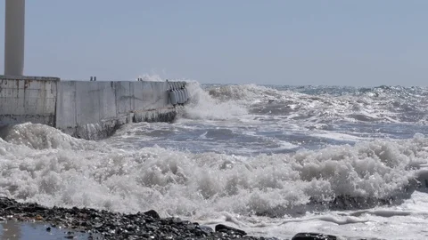 Storm at sea. Large waves crash against the concrete breakwater. Stock Footage 117052850