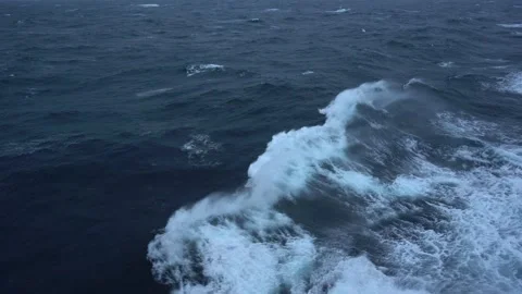 Storm at sea. Side view along ship. Wind blows spray off wave. Wind breaks waves Stock Footage 231515016