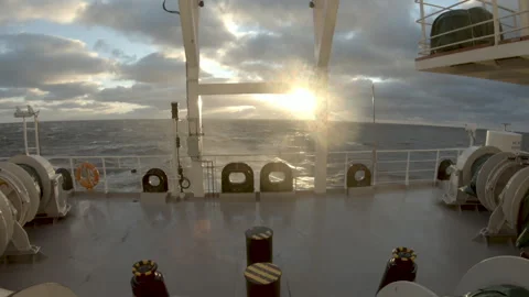 Storm in sea. Splashes from waves from under stern of ship in rays of sun. Stern Stock Footage 258012664