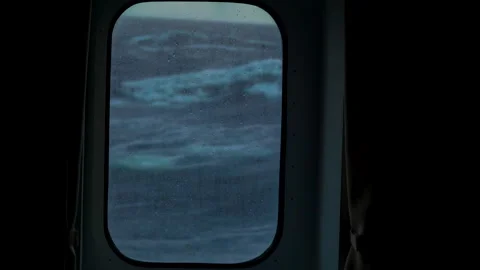 Storm at sea. View through cabin window. Drops on glass in focus. Side pitching Stock Footage 242622389