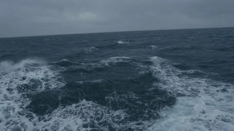 Storm at sea. Waves from ship. Wind breaks waves. White foam on wind. Side view Stock Footage 220668578