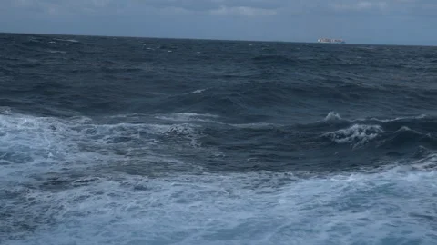 Storm, sea. Wind breaks waves with splashes. Vessel on horizon. White foam on Stock Footage 242540275