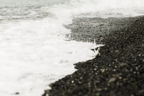 Storm on the seashore , the wave washes the stones Stock Photos