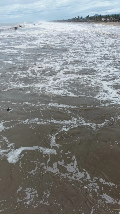 Storm surf rolling along the beach, vertical drone, Pacific near Acapulco Stock Footage 348300200