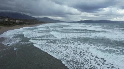 Storm surf rolling onto a sandy beach, aerial view, Crete Stock Footage 346723907