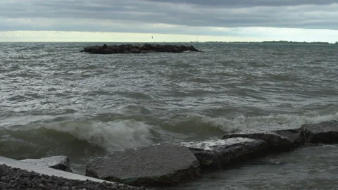 Storm surge splashes against rocks on a beach Stock Footage 132586523
