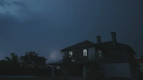 Storm with thunder and lightning over modern cottage Stock Footage 197124676