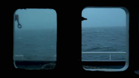Storm. Vessel. View from cabin window. Splashes flie past porthole. Strong side Stock Footage 233381520