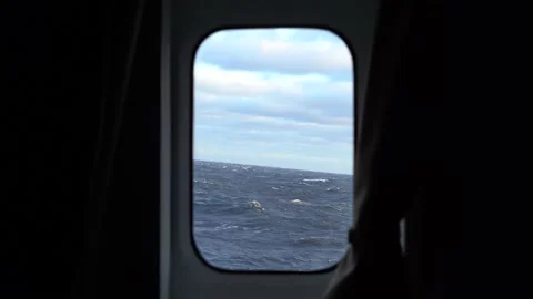 Storm view from cabin window. Strong side pitching. Curtains tilt. High waves Stock Footage 194259115