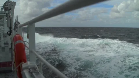 Storm. View from open deck of ship. High waves and splashes along side. White Stock Footage 252490165