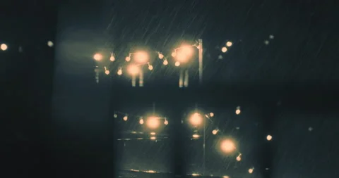 Storm view through window to backyard with string of lights Stock Footage 210221233