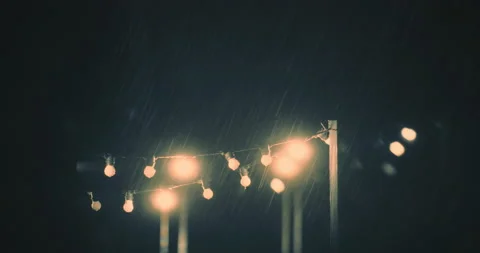 Storm view through window to backyard with string of lights Stock Footage 213356866