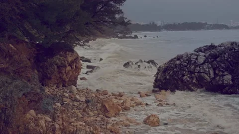 Storm wave moves towards the coast and breaks on the rocks Stock Footage 230922404