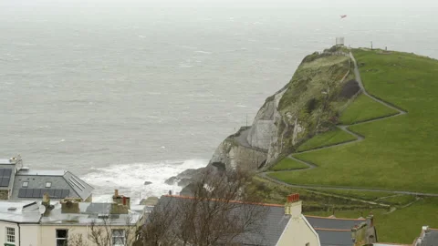 Storm waves and winds buffet rocky outcrop in Ilfracombe Devon Stock Footage 136863261