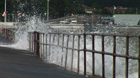 Storm waves crash over barrier Stockbeeldmateriaal 40828329