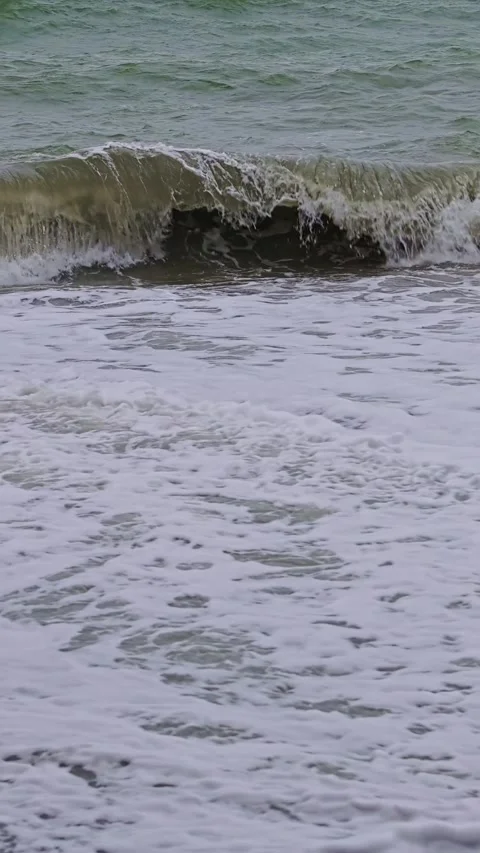 Storm waves crashing onto a pebble beach in the Philippines, Vertical Video. Stock Footage 313526459