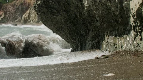 Storm waves destroy the collapsed rock. Long shot taken with a tripod Stock Footage 217729164