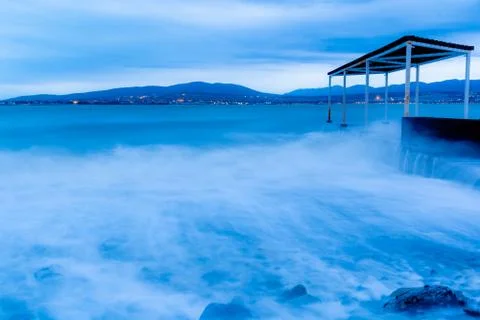 Storm waves at high speed run over the stones of Gelendzhik beach. Waves due  Stock Photos