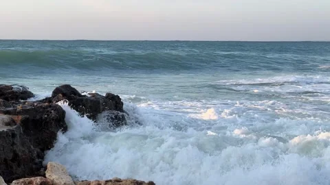 Storm waves hit rocks on the shore in the rays of the sun Stock Footage 280362605
