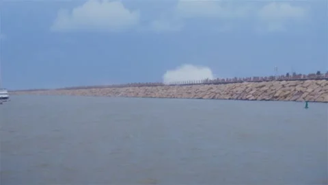 Storm waves hitting long breakwater, dramatic coastal scene Stock Footage 331967987