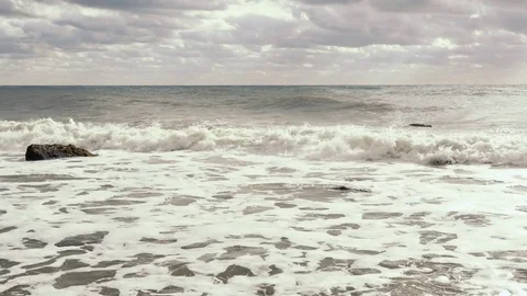 Storm waves roll on stony shore Stock-Footage 81787755